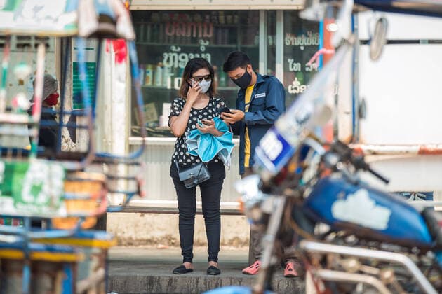 (200323) -- VIENTIANE, March 23, 2020 -- People wearing face masks are seen on the street in Vientiane, Laos, March 23, 2020. Lao people have taken preventive measures against the COVID-19, despite there being no confirmed case of the virus infection in Laos. (Photo by Kaikeo Saiyasane Xinhua) LAOS-VIENTIANE-COVID19-DAILY LIFE ZhangxJianhua 