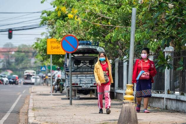(200323) -- VIENTIANE, March 23, 2020 -- People wearing face masks are seen on the street in Vientiane, Laos, March 23, 2020. Lao people have taken preventive measures against the COVID-19, despite there being no confirmed case of the virus infection in Laos. (Photo by Kaikeo Saiyasane Xinhua) LAOS-VIENTIANE-COVID19-DAILY LIFE ZhangxJianhua 