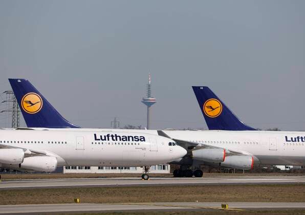 Germany Frankfurt 23 03 2020 Frankfurt Airport the northwest runway becomes a Lufthansa parking lot in the background Frankfurt and the Messertower Wirtschaft Frankfurt Airport runway becomes a parking lot
