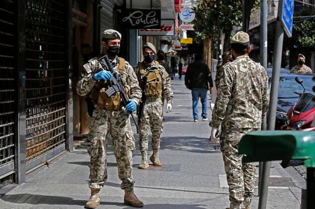 (200323) -- BEIRUT, March 23, 2020 -- Photo taken on March 23, 2020 shows members of the security forces patrol in Beirut, Lebanon. Lebanon s Health Ministry announced on Monday that the number of COVID-19 confirmed cases in the country has risen to 256, the National News Agency reported. Security forces were deployed all over Lebanon to control the movement of people after the tough measures announced by the Lebanese government a day earlier. (Photo by Bilal Jawich Xinhua) LEBANON-BEIRUT-COVID-19 LixLiangyong 