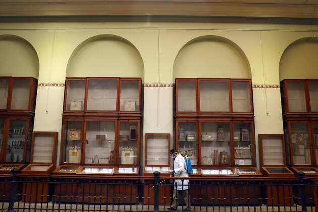 (200323) -- CAIRO, March 23, 2020 -- A man sprays disinfectant at the Egyptian Museum in downtown Cairo, Egypt, March 23, 2020. Egypt confirmed on Sunday 33 new COVID-19 cases, raising the total cases in the country to 327, the Egyptian Health Ministry said in a statement. The Egyptian Ministry of Tourism and Antiquities announced on Saturday the shutting down of all museums and archeological sites and attractions nationwide from March 23 to 31 for sterilization. (Photo by Ahmed Gomaa Xinhua) EGYPT-CAIRO-EGYPTIAN MUSEUM-COVID-19-MEASURES WuxHuiwo 
