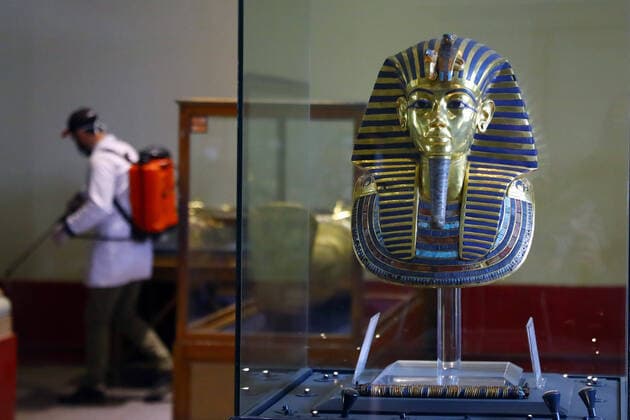 (200323) -- CAIRO, March 23, 2020 -- A man sprays disinfectant near the golden mask of King Tutankhamun at the Egyptian Museum in downtown Cairo, Egypt, March 23, 2020. Egypt confirmed on Sunday 33 new COVID-19 cases, raising the total cases in the country to 327, the Egyptian Health Ministry said in a statement. The Egyptian Ministry of Tourism and Antiquities announced on Saturday the shutting down of all museums and archeological sites and attractions nationwide from March 23 to 31 for sterilization. (Photo by Ahmed Gomaa Xinhua) EGYPT-CAIRO-EGYPTIAN MUSEUM-COVID-19-MEASURES WuxHuiwo 