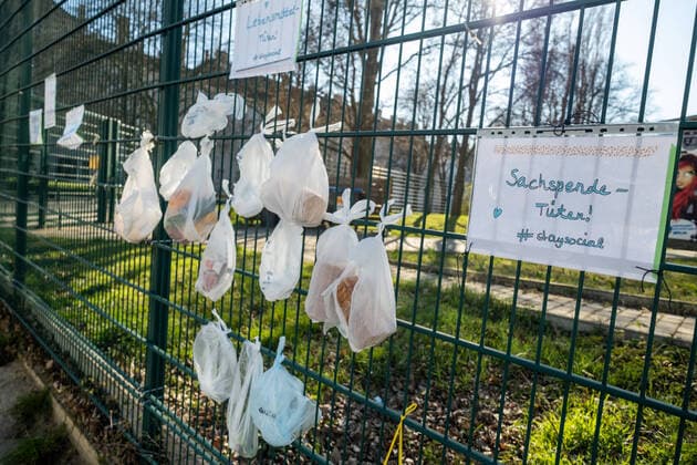 staysocial At the fence of the closed Friedrich Ludwig Jahn Sports Park hang food and donations in kind for homeless people Coronakrise donation fence in Berlin