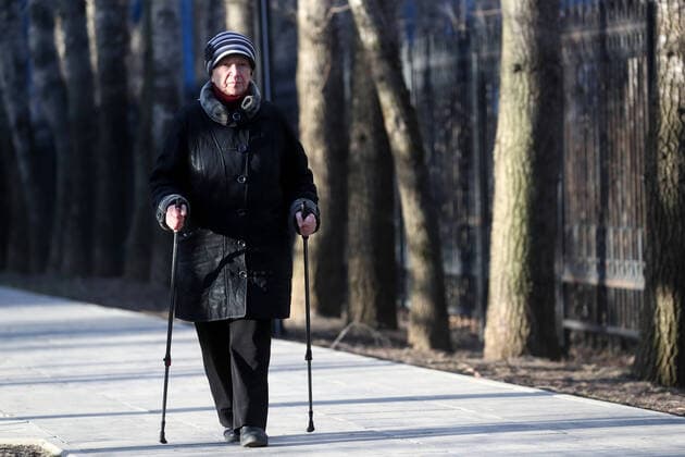 MOSCOW, RUSSIA - MARCH 23, 2020: A woman Nordic walking in Severnoye Tushino Park. Sergei Savostyanov TASS  TS0D3284