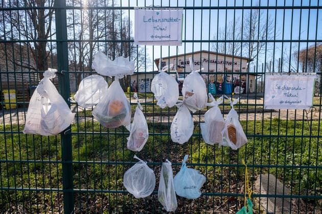 staysocial At the fence of the closed Friedrich Ludwig Jahn Sports Park hang food and donations in kind for homeless people Coronakrise donation fence in Berlin