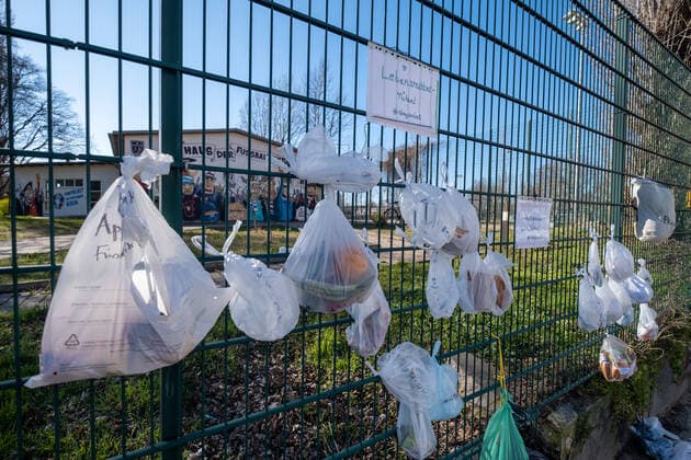 staysocial At the fence of the closed Friedrich Ludwig Jahn Sports Park hang food and donations in kind for homeless people Coronakrise donation fence in Berlin