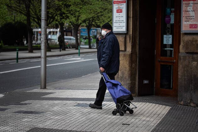 March 23, 2020, San Sebastian, Spain: A man wearing a face mask as a precaution against the spread of Coronavirus walks with his shopping trolley on an empty street in the centre of San Sebastian..Spain registers more than 33,000 cases of coronavirus which means an increase of around 16% of people infected by Covid 19. In addition, the number of people who died from the coronavirus is 2,182 that is 462 more than the day before, which makes Monday 23rd the worst day of the crisis in terms of deaths. San Sebastian Spain - ZUMAs197 20200323_zaa_s197_038 Copyright: xJavixJuliox