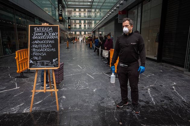 March 23, 2020, San Sebastian, Spain: A man wearing a face mask as a precaution against the spread of Coronavirus holds a disinfectant gel for people entering at the San Martin market for shopping..Spain registers more than 33,000 cases of coronavirus which means an increase of around 16% of people infected by Covid 19. In addition, the number of people who died from the coronavirus is 2,182 that is 462 more than the day before, which makes Monday 23rd the worst day of the crisis in terms of deaths. San Sebastian Spain - ZUMAs197 20200323_zaa_s197_042 Copyright: xJavixJuliox
