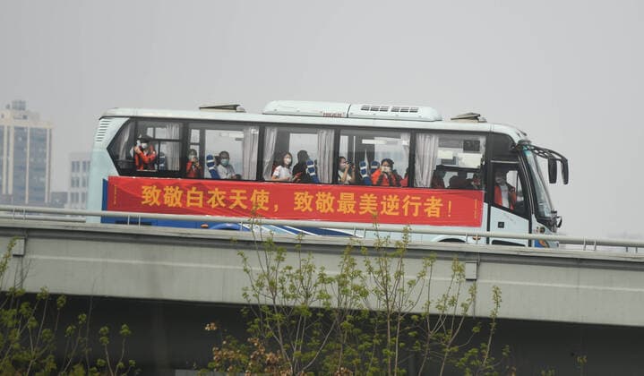 (200323) -- WUHAN, March 23, 2020 -- Medics from Guangdong Province take a bus to the airport in Wuhan, central China s Hubei Province, March 23, 2020. A total of 322 members of a medical assistance team from Guangdong Province left Wuhan of Hubei Province on Monday after finishing their task. ) CHINA-HUBEI-WUHAN-MEDICAL STAFF FROM GUANGDONG-DEPARTURE (CN) ChenxYehua 