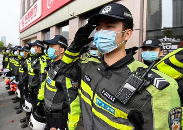 (200323) -- WUHAN, March 23, 2020 -- Policemen salute to medics from Guangdong Province before departure in Wuhan, central China s Hubei Province, March 23, 2020. A total of 322 members of a medical assistance team from Guangdong Province left Wuhan of Hubei Province on Monday after finishing their task. ) CHINA-HUBEI-WUHAN-MEDICAL STAFF FROM GUANGDONG-DEPARTURE (CN) ChenxYehua 