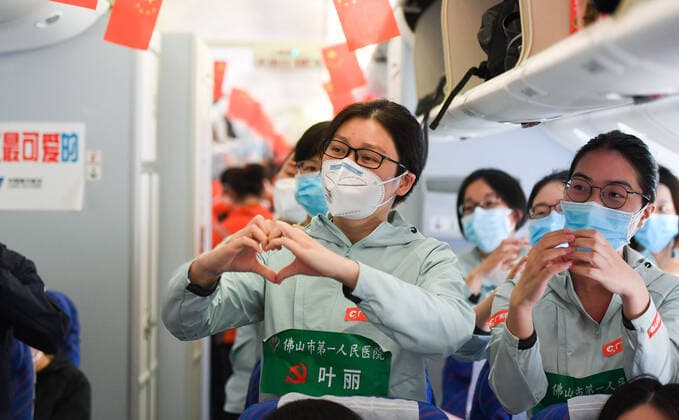 (200323) -- WUHAN, March 23, 2020 -- Medics from Guangdong Province sing a song on the plane in Wuhan, central China s Hubei Province, March 23, 2020. A total of 322 members of a medical assistance team from Guangdong Province left Wuhan of Hubei Province on Monday after finishing their task. ) CHINA-HUBEI-WUHAN-MEDICAL STAFF FROM GUANGDONG-DEPARTURE (CN) ChenxYehua 