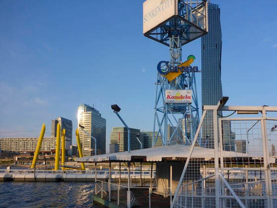 nightlife floating restaurant area Sunken City at river Neue Donau (New Danube) at Donaucity, closed due to corona virus (COVID-19), billboard for Corona beer Wien, Vienna Wien Austria 22. Donaustadt