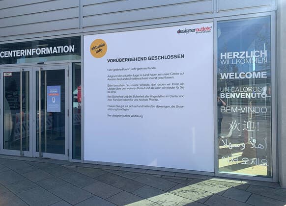 Closed main entrance to the Shopping Outlet Center, sign for closing Wolfsburg