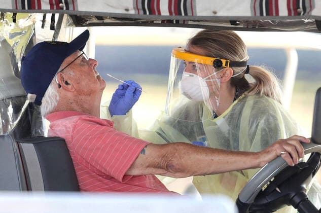 March 23, 2020, The Villages, FL, USA: A resident of The Villages, Fla. gets tested for the coronavirus with a nasal swab at a drive-through site that accomodates golf carts, at The Villages Polo Club, Monday, March 23, 2020. The testing site is being operated by UF Health, with University of Florida medical students performing the tests, and is limited to residents of The Villages only. The Villages USA - ZUMAm67_ 20200323_zaf_m67_012 Copyright: xJoexBurbankx