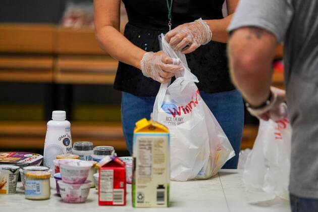 March 23, 2020, Tampa, Florida, USA: Volunteers at the Feeding Tampa Bay distribution center bag essential food items. The center is busier now in response to the pandemic which has caused shortages at grocery stores and is already having an economic impact on families. More volunteers are needed. On Monday, March 23, 2020 in Tampa. Tampa USA - ZUMAs70_ 20200323_zan_s70_014 Copyright: xMarthaxAsencioxRhinex
