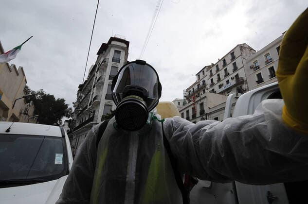 COVID-19 Algeria , Algiers , March 23, 2020 A man disinfects a street of Algiers, Monday, March 23, 2020.Algeria reported a new death from COVID-19 .  Copyright: KADRIxMohamed