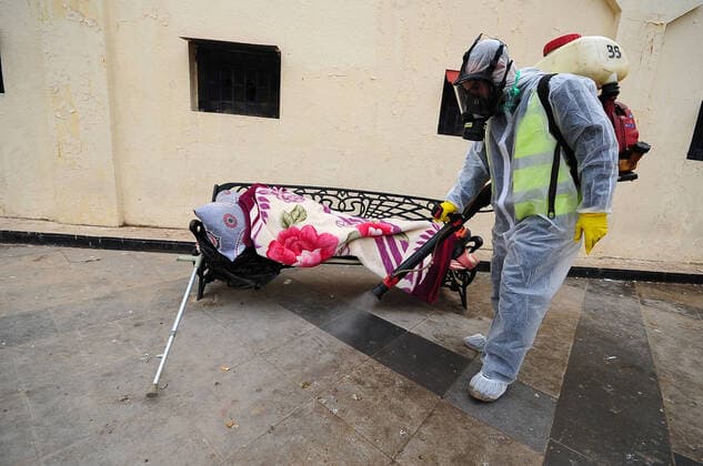 COVID-19 Algeria , Algiers , March 23, 2020 A man disinfects a street of Algiers, Monday, March 23, 2020.Algeria reported a new death from COVID-19 .  Copyright: KADRIxMohamed