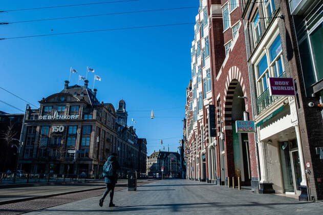 March 23, 2020, Amsterdam, Netherlands: A man walks on an street..Since the Coronavirus hit The Netherlands, most of the cities are empty. A couple of weeks ago, Prime Minister Mark Rutte called to work from home as much as possible and also announced the closure of restaurants, sports clubs, sex clubs, saunas, and cafes. Amsterdam is not formally in lockdown, but the streets and squares are empty. Amsterdam Netherlands - ZUMAs197 20200323_zaa_s197_050 Copyright: xAnaxFernandezx