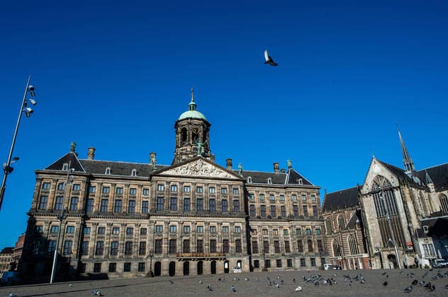 March 23, 2020, Amsterdam, Netherlands: The Dam Square in the center of the city is pictured empty due to the spread of the coronavirus..Since the Coronavirus hit The Netherlands, most of the cities are empty. A couple of weeks ago, Prime Minister Mark Rutte called to work from home as much as possible and also announced the closure of restaurants, sports clubs, sex clubs, saunas, and cafes. Amsterdam is not formally in lockdown, but the streets and squares are empty. Amsterdam Netherlands - ZUMAs197 20200323_zaa_s197_058 Copyright: xAnaxFernandezx