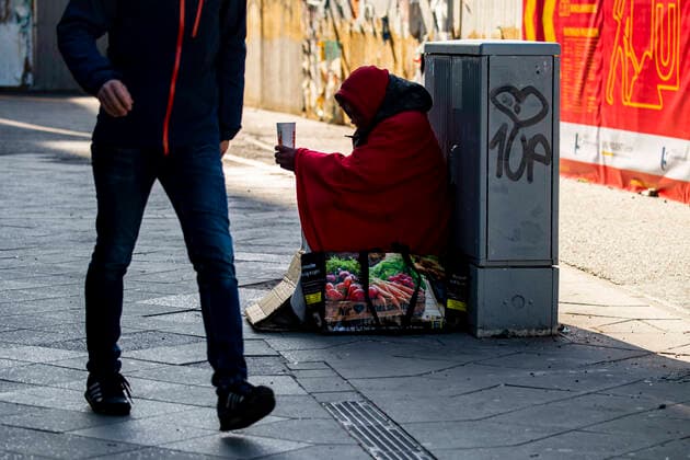 A homeless man asks for money at Alexanderplatz in Berlin on 23 March 2020 In order to slow down the spread of the coronavirus COVID 19, the federal and state governments decided to impose further restrictions After museums, theatres, sports events etc. were banned, from today on m