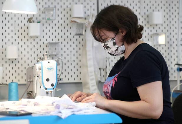 KAZAN, RUSSIA - MARCH 23, 2020: Making reusable face masks at the Chudo Mamy Wonder Moms sewing shop employing mothers of large families and mothers of children with challenges. Yegor Aleyev TASS  TS0D323B