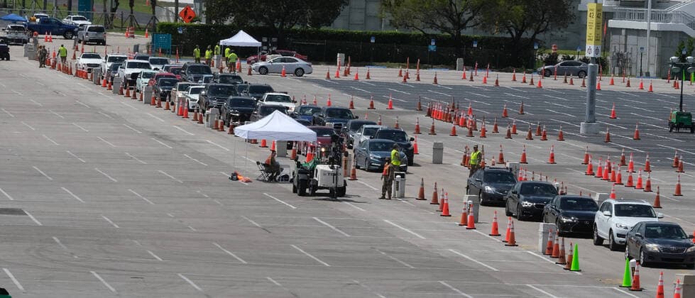 Miami Gardens residents arrive at the testing site to line up in the parking lot of the Hard Rock Stadium on the first day of Coronavirus testing on Monday, March 23, 2020 in Miami Gardens, Florida. This test site is scheduled to handle Miami Gardens area residents over the age of 65 from 7 A.M. to 5 P.M. daily to help identify residents with the Coronavirus.  MIA20200323104 GARYxIxROTHSTEIN