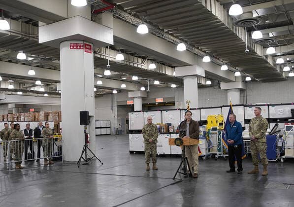Gov. Andrew Cuomo speaks with the National Guard on site at the Jacob Javits Convention Center in New York City on Monday, March 23, 2020. The Javits Center is setting up to be turned into field hospitals to test and possibly treat cases of COVID-19 infections. New York state now accounts for about 1 percent of the coronavirus-related deaths in the world and New York City has more than 12,300 of those cases.  NYP20200323103 JOHNxANGELILLO