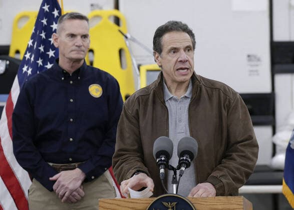 Gov. Andrew Cuomo speaks with the National Guard on site at the Jacob Javits Convention Center in New York City on Monday, March 23, 2020. The Javits Center is setting up to be turned into field hospitals to test and possibly treat cases of COVID-19 infections. New York state now accounts for about 1 percent of the coronavirus-related deaths in the world and New York City has more than 12,300 of those cases.  NYP20200323110 JOHNxANGELILLO