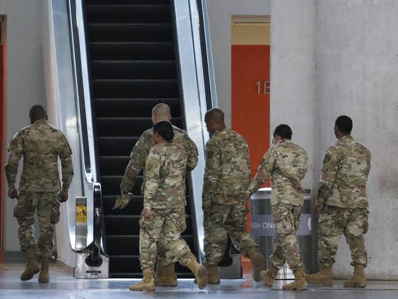 National Guard men and women in uniform walk through the Jacob Javits Convention Center before Gov. Andrew Cuomo speaks with the National Guard on site in New York City on Monday, March 23, 2020. The Javits Center is setting up to be turned into field hospitals to test and possibly treat cases of COVID-19 infections. New York state now accounts for about 1 percent of the coronavirus-related deaths in the world and New York City has more than 12,300 of those cases.  NYP20200323113 JOHNxANGELILLO