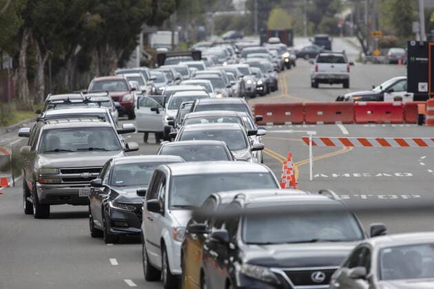 Cars queue for a drive up COVID-19 testing station manned by Hayward emergency-medical technicians in Hayward, California on Monday, March 23, 2020. If the individual has symptoms, they are directed to be tested for CIVID-19 at a separate testing tent.  SFP2020032327 PETERxDASILVA