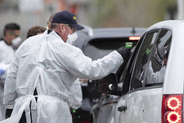 Hayward emergency-medical technicians check members of the public for symptoms and high temperature at a Coronavirus drive up triage station in Hayward, California on Monday, March 23, 2020. If the individual has symptoms, they are directed to be tested for CIVID-19 at a separate testing tent.  SFP2020032330 PETERxDASILVA