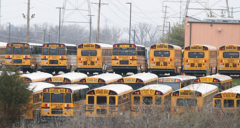 Buses sit idle as school resumes after spring break, in the Parkway School District, in Chesterfield, Missouri on Monday, March 23, 2020. Students are in classes but is being done by computer due to Coronavirus fears.  SLP2020032306 BILLxGREENBLATT
