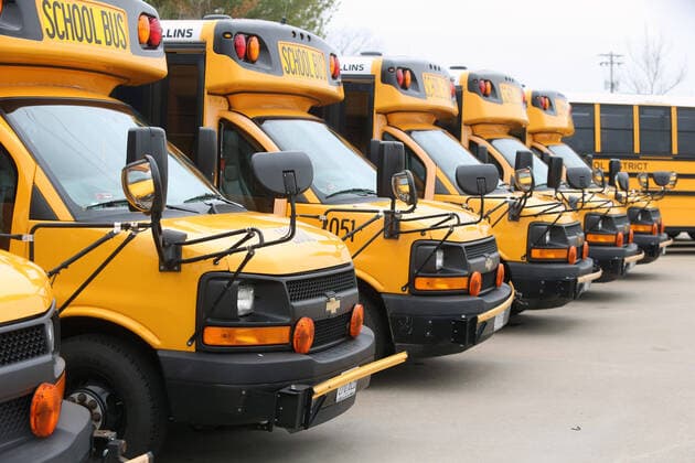 Buses sit idle as school resumes after spring break, in the Parkway School District, in Chesterfield, Missouri on Monday, March 23, 2020. Students are in classes but is being done by computer due to Coronavirus fears.  SLP2020032307 BILLxGREENBLATT