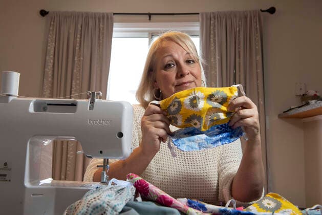 March 21, 2020, Woodstock, GA: Kathy Ahlberg, 53, volunteered to sew several hundred masks from donated materials, to be given to doctors and nurses struggling to stay safe in the midst of the coronavirus crisis. She is one of nearly 450 volunteers in the Atlanta area who donate their skills to produce the fabric masks. Woodstock - ZUMAn03_ 20200321_zaf_n03_004 Copyright: xRobinxRaynex