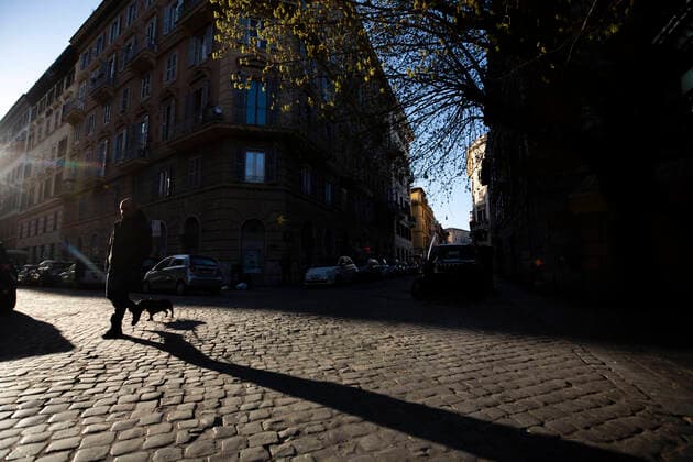 Italy: Rome sites during the Coronavirus outbreak A man walks with a dog in Trastevere in Rome during the 14th day of lockdown imposed nationwide by the Italian government that tries to tackle the coronavirus outbreak. Every movements in the citiies are restricted, and streets usually filled with life and traffic are almost empty Roma Italy Italy Copyright: GiuseppexFama
