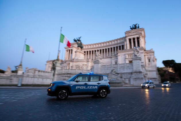 Italy: Rome sites during the Coronavirus outbreak A police car pass in front of the Vittoriano in Piazza Venezia in Rome during the 14th day of lockdown imposed nationwide by the Italian government that tries to tackle the coronavirus outbreak. Every movements in the citiies are restricted, and streets usually filled with life and traffic are almost empty Roma Italy Italy Copyright: GiuseppexFama