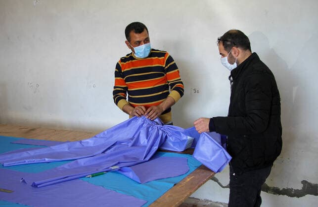 (200323) -- BEIT LAHIA, March 23, 2020 (Xinhua) -- Palestinian workers make protective suits at a factory in the northern Gaza Strip town of Beit Lahia, on March 22, 2020. A Gaza factory, which is located in the coastal enclave town of Beit Lahia, has succeeded in producing protective suits following China s standards. (Photo by Rizek Abdeljawad Xinhua) TO GO WITH Feature: Gaza factory follows China s standards to produce protective suits amid COVID-19 MIDEAST-GAZA-BEIT LAHIA-COVID-19-PROTECTIVE SUITS-PRODUCTION 