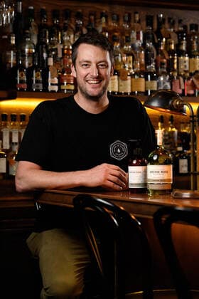 ARCHIE ROSE GIN HAND SANITISER, Archie Rose Distilling Group Bar Manager Lewis Jaffrey poses with a bottle of their Gin infused hand sanitiser and signature gin, in Sydney, Tuesday, March 24, 2020. Using leftover botanicals from their gin, the idea to produce the hand sanitiser came from trying to keep their bar staff employed during the COVID-19 shut down of license venues. The hand sanitiser has so far sold out online, but will be sold to the general public and wholesalers. ( NO ARCHIVING, EDITORIAL USE ONLY, NO USE IN BOOKS WITHOUT CONSENT SYDNEY NSW AUSTRALIA  Copyright: xBIANCAxDExMARCHIx 20200324001459061838