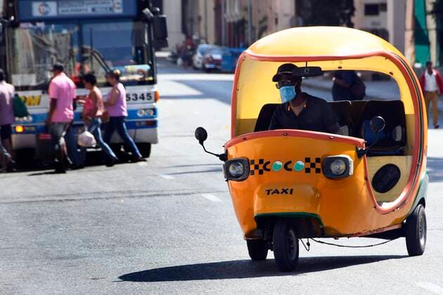 (200324) -- HAVANA, March 24, 2020 (Xinhua) -- A taxi driver wearing a mask is seen on a street in Havana, Cuba, March 23, 2020. Cuban President Miguel Diaz Canel on Monday urged state institutions, private sectors and people to increase control and discipline in an effort to contain the COVID-19 outbreak. (Photo by Joaquin Hernandez Xinhua) CUBA-HAVANA-COVID-19 