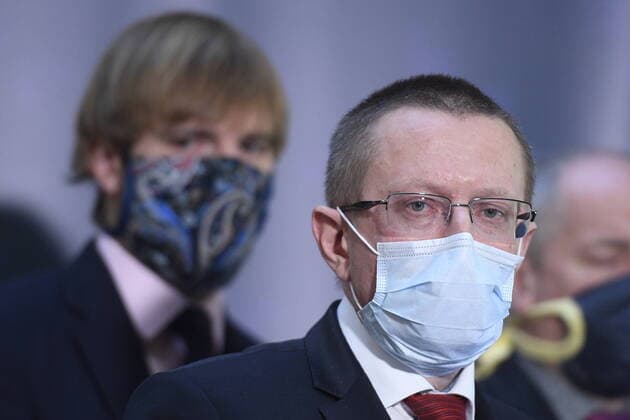 Czech Health Minister Adam Vojtech, left, and Czech Institute of Health Information and Statistics (UZIS) director Ladislav Dusek, center, with a protection face masks attend a press conference on assessment of development of COVID-19 illness, on March 24, 2020, in Prague, Czech Republic. (CTKxPhoto OndrejxDeml) CTKPhotoP202003240226001 _DML8718