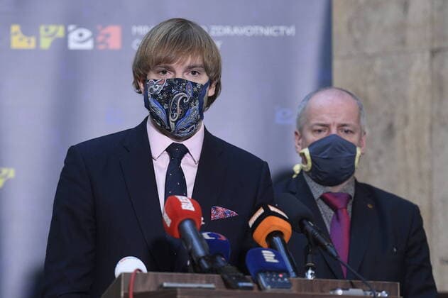 Czech Health Minister Adam Vojtech, left, and Deputy Health Minister and Central Crisis Staff head Roman Prymula, right, with a protection face masks attend a press conference on assessment of development of COVID-19 illness, on March 24, 2020, in Prague, Czech Republic. (CTKxPhoto OndrejxDeml) CTKPhotoP202003240234501 _DML8627