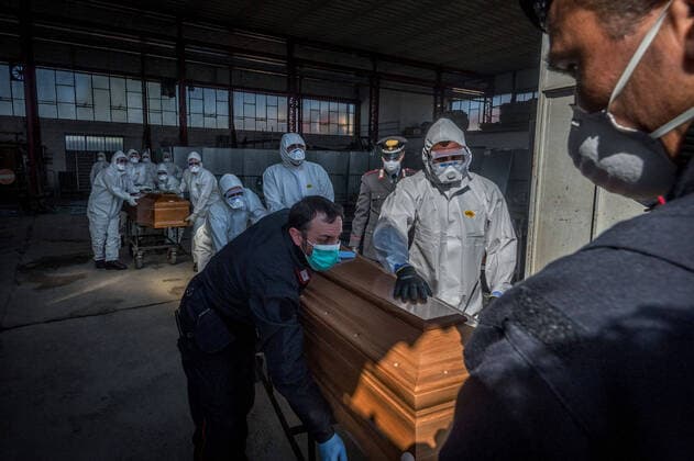 Ponte San Pietro (Bergamo). Military and medical personnel of the Army together with the Carabinieri transport the coffins with the use of six trucks from a depot in Ponte San Pietro due to emergency COVID19 Coronavirus (Carlo Cozzoli Fotogramma, San Pietro bridge - 2020-03-24) p.s. la foto e utilizzabile nel rispetto del contesto in cui e stata scattata, e senza intento diffamatorio del decoro delle persone rappresentate  Copyright: xCarloxCozzolix xFOTOGRAMMAx