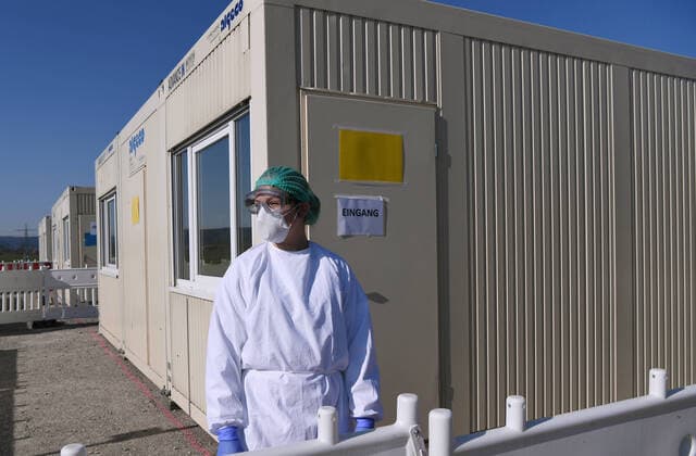 Tuebingen 24 03 2020 Corona Container Outpatient Clinic Tuebingen, Covid 19 Care at the Tuebingen fairground A medical student is waiting in front of a container for patients for outpatient care ULMER