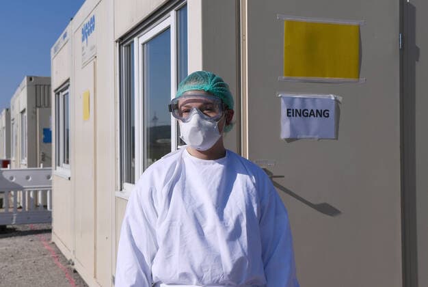 Tuebingen 24 03 2020 Corona Container Outpatient Clinic Tuebingen, Covid 19 Care at the Tuebingen fairground A medical student is waiting in front of a container for patients for outpatient care ULMER
