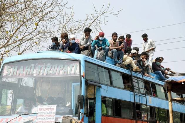 PATNA, INDIA - MARCH 23: Commuters seen atop a overcrowded bus during the first day of lockdown imposed by the state government to curb the spread of coronavirus , on March 23, 2020 in Patna India.(Photo Santosh Kumar Hindustan Times) First day Of Lockdown In Patna