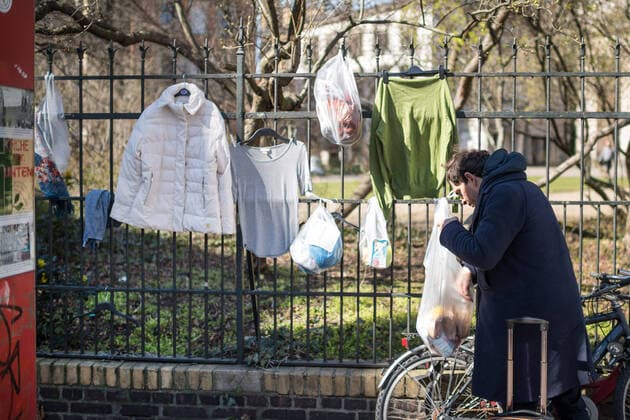 A homeless person takes food from the donation fence at the Protestant church community at Weinberg in Berlin Mitte Photo of 24 03 2020 So-called donations or d Copyright: epd-bild ChristianxDitsch EDITORIAL USE ONLY