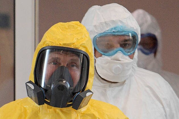 MOSCOW, RUSSIA - MARCH 24, 2020: Russia s President Vladimir Putin wears a yellow protective suit on his visit to the Novomoskovsky multipurpose medical center for patients suspected of the COVID-19 coronavirus infection. Alexei Druzhinin Russian Presidential Press and Information Office TASS  TS0D3381
