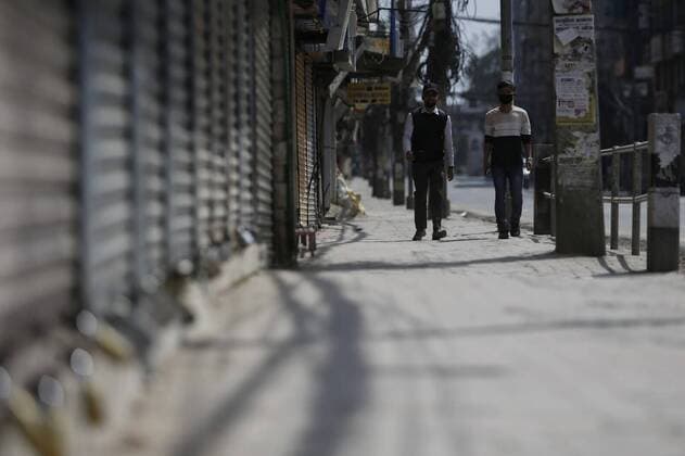 (200324) -- KATHMANDU, March 24, 2020 -- People walk at a closed market in Kathmandu, Nepal, March 24, 2020. Nepal on Monday decided to enforce a national lockdown for a week effective from Tuesday to prevent the spread of COVID-19. (Photo by Xinhua) NEPAL-KATHMANDU-COVID-19-LOCKDOWN SulavxShrestha 