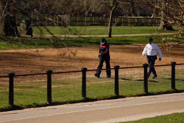 (200324) -- LONDON, March 24, 2020 -- People walk appearing to follow social distancing guidelines in Hyde Park after the British government placed further restrictions on movement in London, Britain on March 24, 2020. British Prime Minister Boris Johnson announced Monday evening a series of measures that aim to restrict social contact in the UK, so as to curb the spread of COVID-19. Starting from Monday night, people in Britain will only be allowed to leave their homes for very limited purposes , including shopping for basic necessities, for any medical need, for one form of exercise a day, and to travel to and from work when necessary, said the prime minister. (Photo by Tim Ireland Xinhua) BRITAIN-LONDON-COVID-19 HanxYan 
