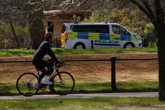 (200324) -- LONDON, March 24, 2020 -- Policemen drive a van in Hyde Park after the British government placed further restrictions on movement in London, Britain, March 24, 2020. British Prime Minister Boris Johnson announced Monday evening a series of measures that aim to restrict social contact in the UK, so as to curb the spread of COVID-19. Starting from Monday night, people in Britain will only be allowed to leave their homes for very limited purposes , including shopping for basic necessities, for any medical need, for one form of exercise a day, and to travel to and from work when necessary, said the prime minister. (Photo by Tim Ireland Xinhua) BRITAIN-LONDON-COVID-19 HanxYan 